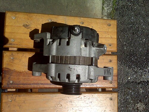 A vehicle alternator with a metal housing, cooling vents and belt pulley