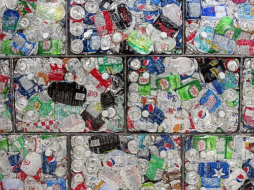 A close view of crushed aluminium drink cans in recycling bales
