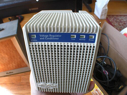 A cased voltage regulator with a ribbed front and indicator lights