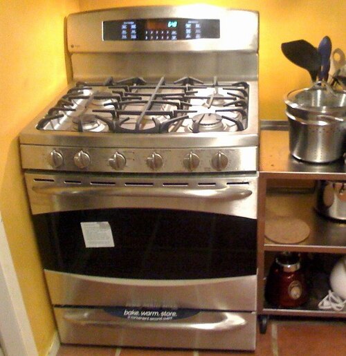 A freestanding gas cooker with burners, controls and an oven door