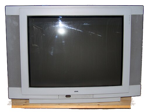 A grey CRT television with a deep casing and curved glass screen