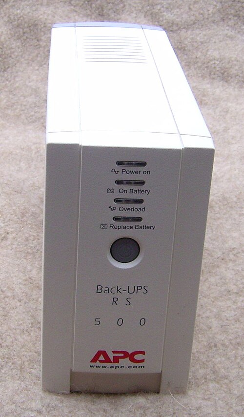 A white upright APC uninterruptible power supply with front status lights